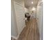 Hallway with wood flooring features built-in desk and cabinetry, leading to laundry room at 5269 Parkhurst Xing, McCordsville, IN 46055