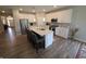This open concept kitchen features an island with seating and stainless steel appliances at 5269 Parkhurst Xing, McCordsville, IN 46055