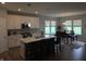 Modern kitchen with white cabinetry, stainless steel appliances, a spacious island, and an adjacent dining area at 5269 Parkhurst Xing, McCordsville, IN 46055