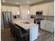 This open kitchen has an island, stainless steel appliances, and white cabinets at 5269 Parkhurst Xing, McCordsville, IN 46055
