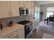 This updated kitchen features stainless steel appliances, white cabinets, and stone countertops at 5269 Parkhurst Xing, McCordsville, IN 46055