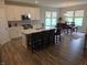 Bright open-concept kitchen featuring a center island, stainless appliances, and an adjacent dining space at 5269 Parkhurst Xing, McCordsville, IN 46055