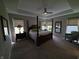 Spacious main bedroom with a four-poster bed, tray ceiling, fan and natural light at 5269 Parkhurst Xing, McCordsville, IN 46055