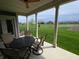 Cozy covered patio featuring a round table, chairs and a serene view of the green lawn at 5269 Parkhurst Xing, McCordsville, IN 46055