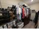 Organized walk-in closet with shelving and dresser for clothing at 5269 Parkhurst Xing, McCordsville, IN 46055