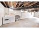 Unfinished basement with laundry area featuring a washer, dryer, and utility sink, offering functionality and potential at 548 E 39Th St, Indianapolis, IN 46205