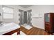 Bathroom featuring a walk-in shower and wooden floors at 548 E 39Th St, Indianapolis, IN 46205