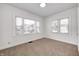 Bright bedroom with neutral carpet and two large windows at 548 E 39Th St, Indianapolis, IN 46205
