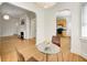 Open-concept dining area with hardwood floors, a pendant light, with views of the kitchen and living room at 548 E 39Th St, Indianapolis, IN 46205