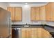 Kitchen showcasing wood cabinets, stainless steel appliances and a sleek countertop at 548 E 39Th St, Indianapolis, IN 46205