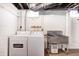 A laundry area equipped with a washer, dryer, and utility sink, providing a functional space for household chores at 548 E 39Th St, Indianapolis, IN 46205