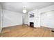 Open living room with hardwood floors, a fireplace, and doorway leading to other rooms at 548 E 39Th St, Indianapolis, IN 46205