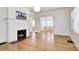 Open living room showcases hardwood floors, fireplace with a painting, and an arched doorway to the dining area at 548 E 39Th St, Indianapolis, IN 46205