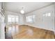 Bright living room featuring hardwood floors, a fireplace, and a doorway leading to the dining area at 548 E 39Th St, Indianapolis, IN 46205