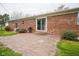 Brick patio and backyard showing the brick exterior of the home with sliding glass doors at 5555 W Vermont St, Indianapolis, IN 46224