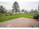 Expansive backyard featuring lush green grass and a brick patio, perfect for outdoor entertaining at 5555 W Vermont St, Indianapolis, IN 46224