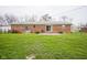 Large backyard and brick ranch home, complete with a brick patio and sliding glass door at 5555 W Vermont St, Indianapolis, IN 46224