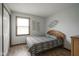 Bedroom with wood-look floors, cozy bed and modern wall decor at 5555 W Vermont St, Indianapolis, IN 46224