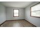 Inviting bedroom with wood-look floors and natural light from two windows at 5555 W Vermont St, Indianapolis, IN 46224