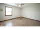 Neutral bedroom with natural light, wood-look floors, and clean lines at 5555 W Vermont St, Indianapolis, IN 46224