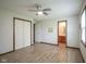 Bright, spacious bedroom with wood-look flooring and ensuite bath access at 5555 W Vermont St, Indianapolis, IN 46224