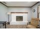 Attractive brick fireplace with wooden mantle and hearth at 5555 W Vermont St, Indianapolis, IN 46224