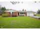 Charming brick home featuring an attached garage and a well-maintained lawn at 5555 W Vermont St, Indianapolis, IN 46224