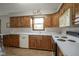 Well-lit kitchen with wooden cabinets, white countertops, and modern appliances at 5555 W Vermont St, Indianapolis, IN 46224