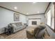 Cozy living room featuring a brick fireplace, new floors and ample natural light at 5555 W Vermont St, Indianapolis, IN 46224