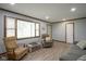 Spacious living room showcasing a large window and new laminate flooring at 5555 W Vermont St, Indianapolis, IN 46224