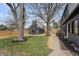 View of a well-manicured backyard, featuring a shed, lush green lawn, and newly mulched flowerbeds at 5954 Crestview Ave, Indianapolis, IN 46220