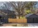 This residence boasts a large, fenced backyard, complemented by a matching garage and a neatly manicured lawn at 5954 Crestview Ave, Indianapolis, IN 46220