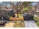 Aerial view of a backyard featuring a detached garage, a gravel driveway, and a wooden fence at 5954 Crestview Ave, Indianapolis, IN 46220