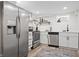 This basement kitchen features stainless steel appliances, a wood shelf, and black hardware at 5954 Crestview Ave, Indianapolis, IN 46220