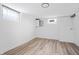 Unfurnished basement with light wood flooring, neutral walls, and glass block windows at 5954 Crestview Ave, Indianapolis, IN 46220