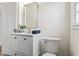 This bathroom features a white vanity, toilet, a gold trimmed mirror, and natural light at 5954 Crestview Ave, Indianapolis, IN 46220