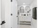 Modern bathroom with double vanity, black fixtures, and marble floors at 5954 Crestview Ave, Indianapolis, IN 46220