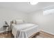 Cozy bedroom with a full sized bed, simple decor, wood floors, and natural light from a glass block window at 5954 Crestview Ave, Indianapolis, IN 46220