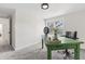 This bedroom features a green desk, grey carpet, a window with natural light, and white walls at 5954 Crestview Ave, Indianapolis, IN 46220