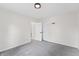 This bedroom features a ceiling light, grey carpet, two white doors and white walls at 5954 Crestview Ave, Indianapolis, IN 46220