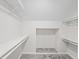 Spacious walk-in closet featuring shelves, storage, and neutral carpet at 5954 Crestview Ave, Indianapolis, IN 46220