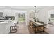 An open dining room sits next to the kitchen with lots of natural light and modern fixtures at 5954 Crestview Ave, Indianapolis, IN 46220