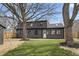 Charming two-story home featuring a dark exterior and a lush, well-maintained front yard and newly landscaped flowerbeds at 5954 Crestview Ave, Indianapolis, IN 46220