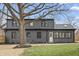 The back of the two-story home featuring a newly landscaped lawn, garden beds, and freshly mulched flowerbeds at 5954 Crestview Ave, Indianapolis, IN 46220