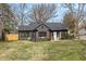 Charming renovated single-Gathering home with a dark exterior, new landscaping, and a well-manicured lawn at 5954 Crestview Ave, Indianapolis, IN 46220