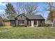 Charming home featuring a brick exterior, stylish shutters, landscaping, and a well-maintained front yard at 5954 Crestview Ave, Indianapolis, IN 46220