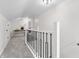 Bright hallway featuring modern railings, neutral carpet, and an elegant console table at 5954 Crestview Ave, Indianapolis, IN 46220
