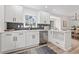 Modern kitchen featuring white cabinets, stainless steel appliances, and stylish backsplash at 5954 Crestview Ave, Indianapolis, IN 46220