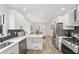 Bright kitchen boasts stainless steel appliances, ample cabinet space, and a dining area view at 5954 Crestview Ave, Indianapolis, IN 46220