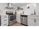 Bright kitchen with stainless steel appliances, white cabinets, and stylish faucet at 5954 Crestview Ave, Indianapolis, IN 46220
